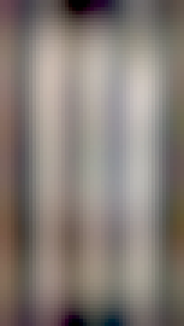 Myself holding a phone with a damaged screen and a black blotting in the top right corner.