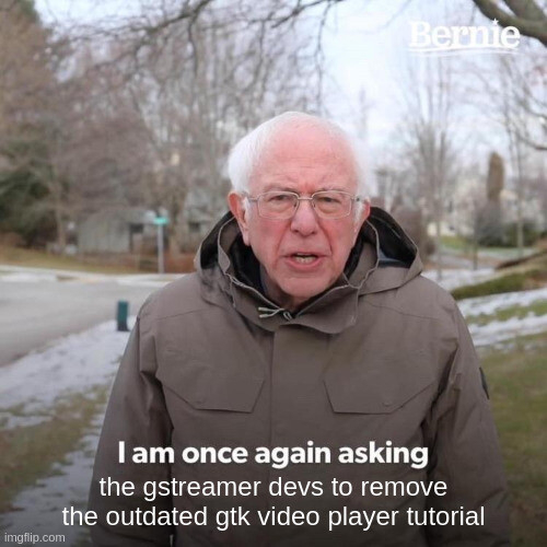 Bernie Sanders in winter attire, in a park, asking once again the gstreamer devs to remove the outdated gtk video player tutorial from their documentation website
