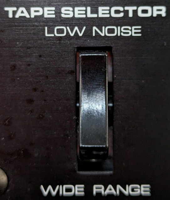 a rocker switch with "tape selector" written on top. the options are "low noise" and "wide range"