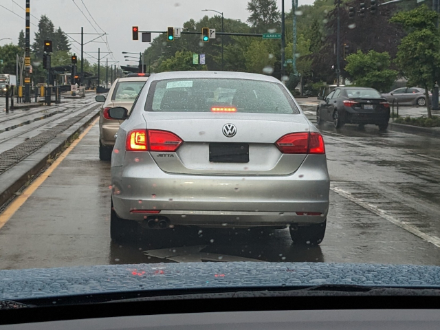 Rear of VW car with a black license plate that looks like a famous trim mustache.