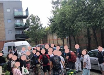 About two dozen anti-fascists block a immigration raid van and police escort in Peckham, south London. 