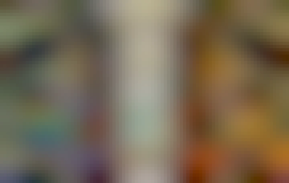 Inside of the Sagrada familia with Deep blue and intense red stained glass on opposite side