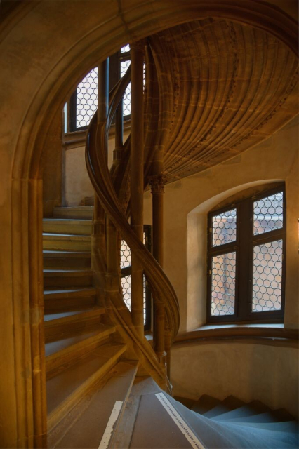 Winding stone staircases flooded in golden light
