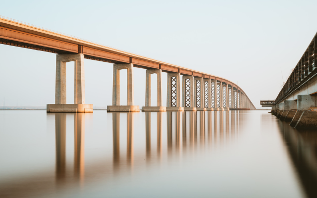 photo of two bridges side by side over water 