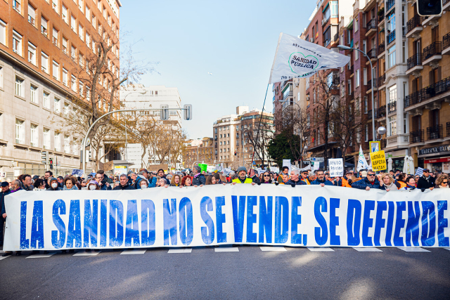 Foto general de plano abierto de la cabecera principal, en la que se muestra el lema "LA SANIDAD NO SE VENDE SE DEFIENDE" de la Columna este de la Manifestación por la Sanidad en Madrid que sale desde el Hospital de La Princesa.