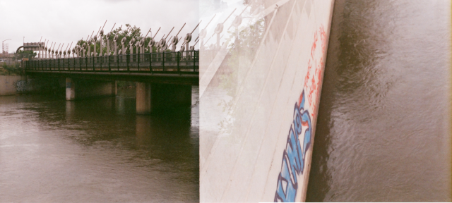 two overlapping shots:
to the left, a bridge over a river, to the right, the river and graffiti on a wall