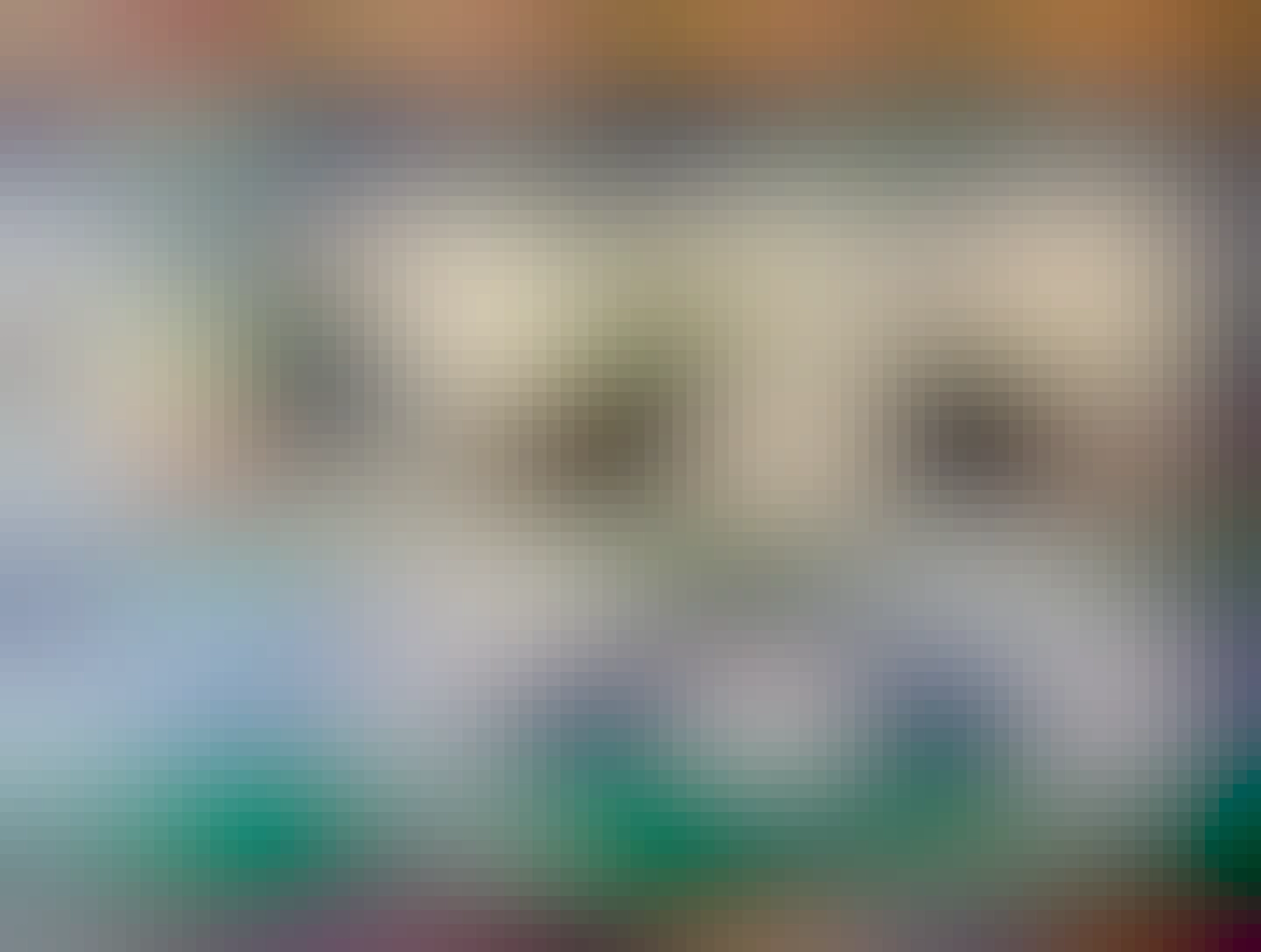 A photograph of a wall mounted, plastic cow, that dispenses condiments from its udders. Really