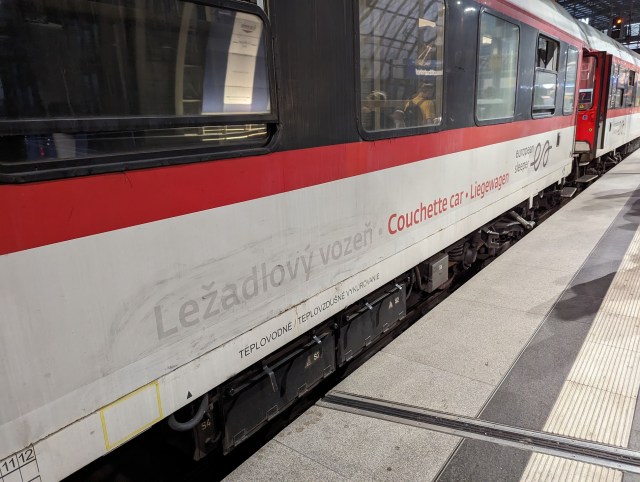 A side view of European Sleeper Couchette car with visible marks of removed sign „Ležadlový vozeň.“