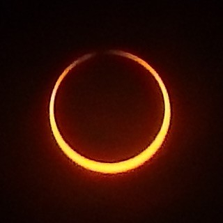 Ring of yellow light, thicker at the bottom and possibly not meeting at the top
