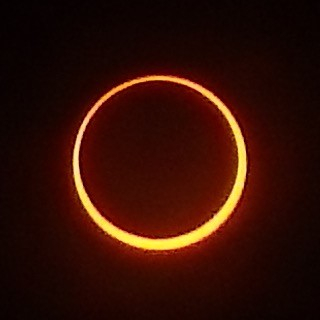 A ring of yellow light, slightly thicker at the bottom and on the right