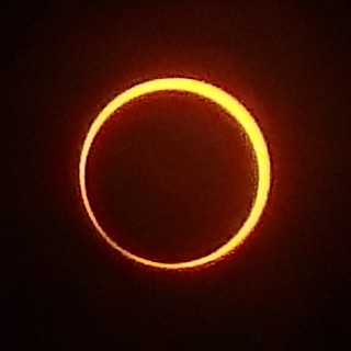 A ring of yellow light, thicker at the top-right and only just there at the bottom-left
