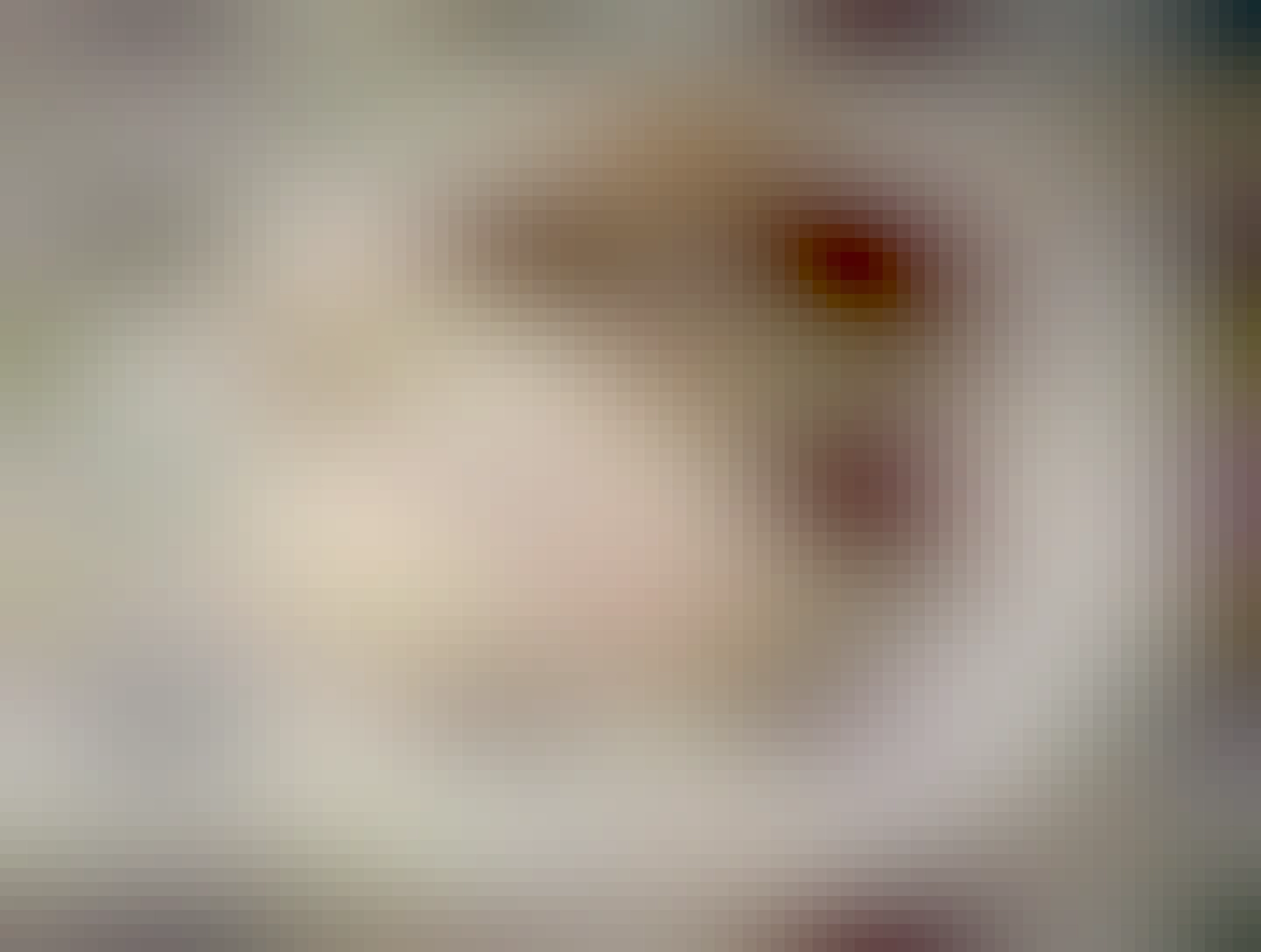 A plate divided between white basmati rice and baingan bartha: a curry with soft eggplant pieces mixed into it, slightly yellowish, with some red bell peppers sticking out. Some eggplant seeds are visible