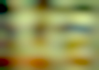 An old photo of a computer desk in fuzzy 1990s Quality. A beige mac with beige keyboard and computers sits on the desk, with floppy disks and a couple of laptops on the shelf above. An uncomfortable wooden chair sits in front of the desk. An iPhone 7 sits quietly to the side.