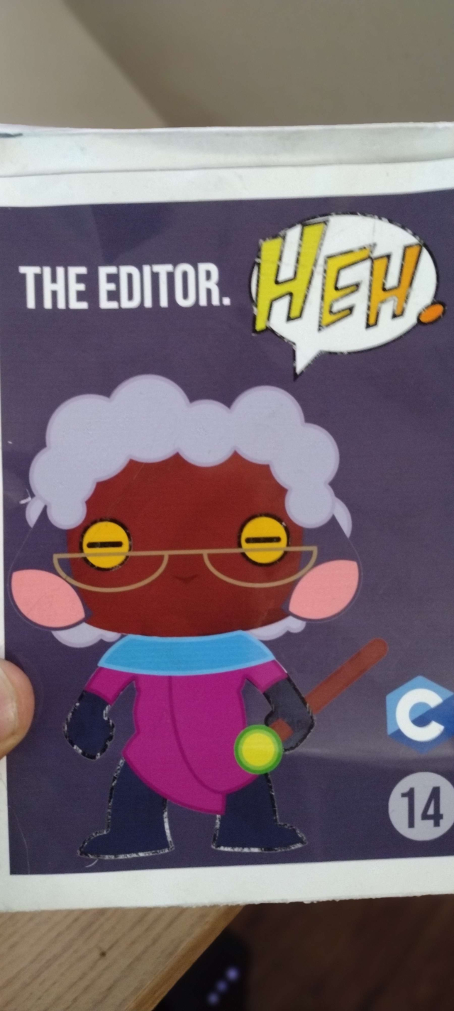 The back of the rectangular box. It shows a facsimile of the character contained within, in the same pose. It's modeled after the art done by KIING KIISMET (https://kiingkiismet.com/);

The sheep is wearing a turquoise neck scarf and purple robes that go all the way down to their boots. The eyes are sheep-like, yellow with horizontal pupils.