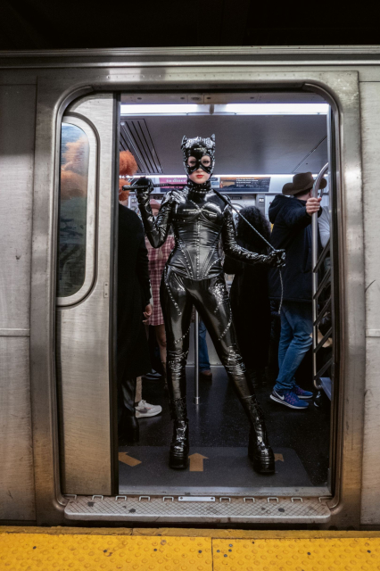 Woman dressed as Catwoman in the open door of the subway. Picture by Seymour Licht