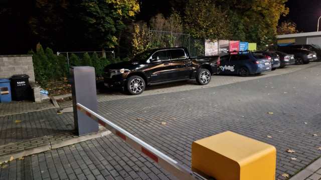 Dodge Ram like car parked over two slots.