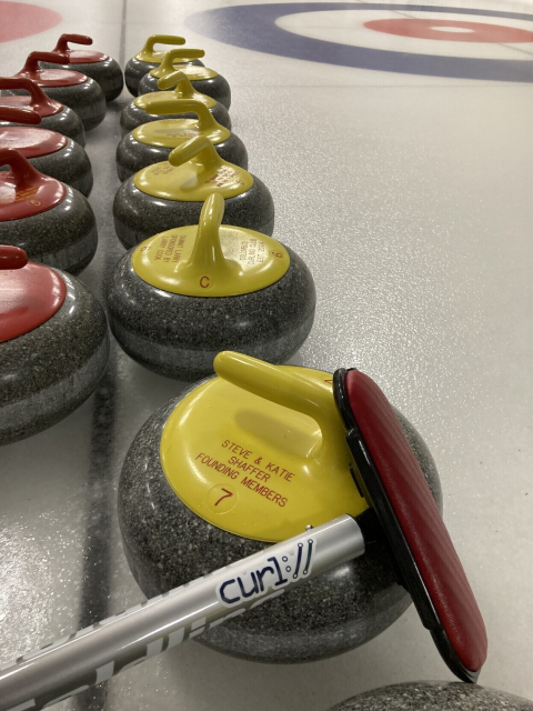 curling stones and a curling broom featuring a curl sticker