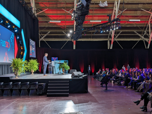 Minister Terry Beech speaking to a crowd at FWD50. 