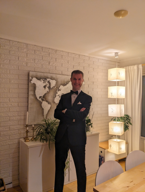 Daniel wearing a suit, smiling. 