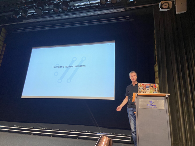 Daniel presenting at pycon. The current slide says "everyone makes mistakes"