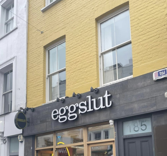 restaurant in london: facade reads eggslut. yellow brick building. rainy grey london day
