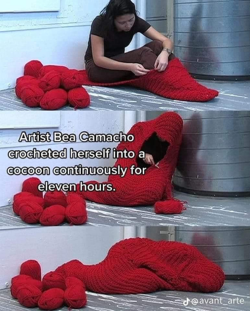 A collage of three photos, with a text that reads: Artist Bea Camacho crocheted herself into a cocoon continuously for eleven hours. In the first image a woman with black hair, black t-shirt and brown trousers sits on the floor. There's a large stack of skeins of red yarn beside her. She sits on a blanket crocheted from the yarn and has begun to crochet it into a cocoon that covers her feet. In the next image she sits slumped and leaning against the wall, with the cocoon almost finished, save for a gap around her hands. In the last image she's fully cocooned and lies in a fetal position on the floor.