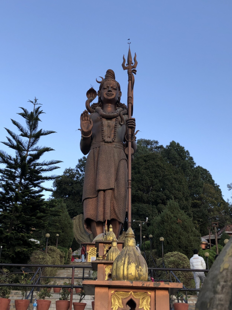 The world's tallest statue of Lord Shiva. He has a cobra wrapped comfortably like a scarf, and is holding a trident.