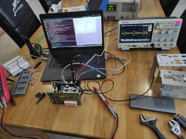 A Selectron CPU831 TCMS/PLC on a workbench, being probed and programmed.