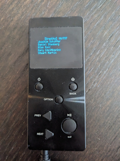 Photo of an mp3 player showing a credits page with Daniel Stenberg listed