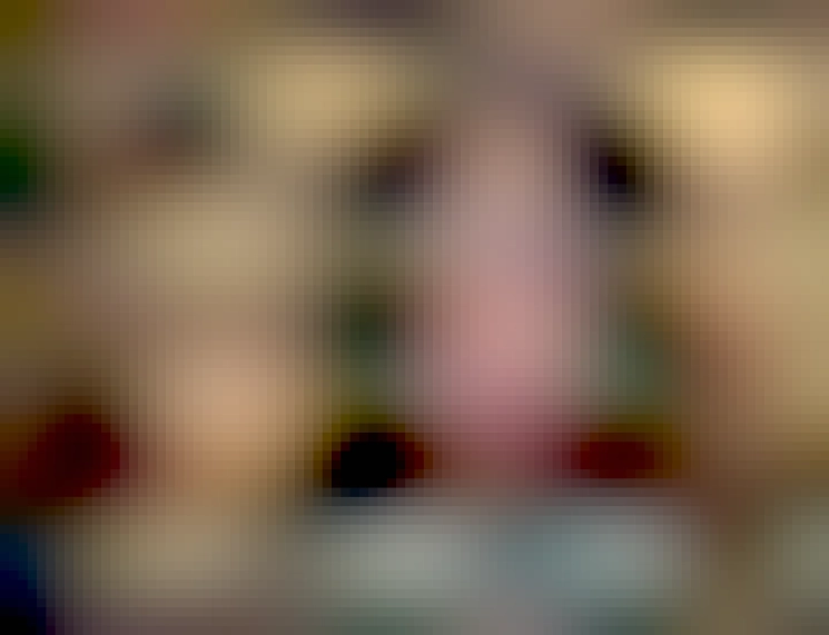 Estelle made up as Gene Simmons from the band Kiss, in full podcast mode.