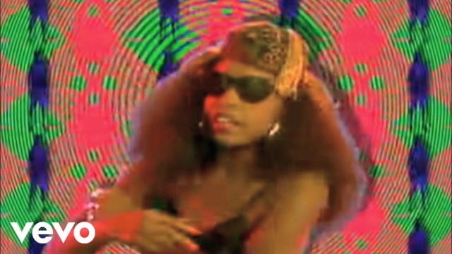 Screenshot from "Technotronic - Pump Up The Jam" official Music Video

black woman, long hair, sunglasses, weird colorful background

Vevo logo in the corner