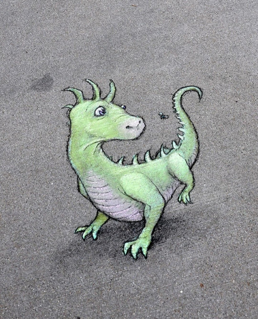 Streetart. A small green dragon has been drawn with chalk on a gray sidewalk. The dragon looks around in surprise at a fly circling around its long tail. Title: "Any time he gets surprised, Alfie experiences what he calls "the reverse tyrannosaur."