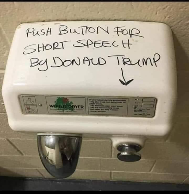 A bathroom hand dryer on which someone has written “push button for a short speech by Donald Trump” 