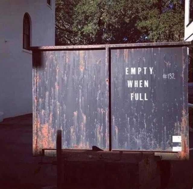 Dumpster with sign. 
“Empty
When
Full”