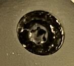 a very shitty looking screw with a hexagonal socket