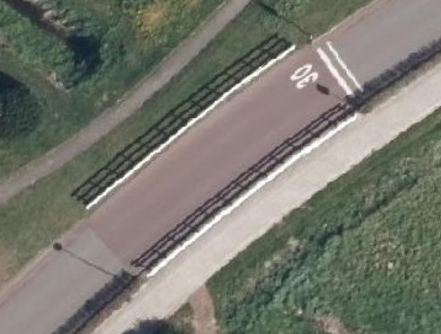 Aerial photo showing road surrounded by fences, looking like bridge.

Aerial photo by Kadaster / Beeldmateriaal.nl, CC BY 4.0