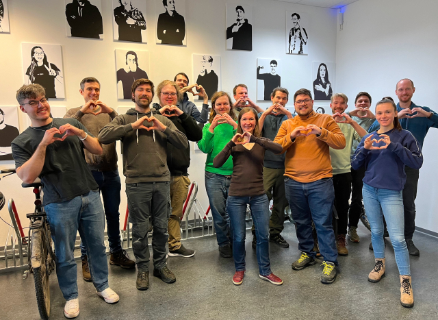 Picture of the Tuta Team making hearts with their hands.