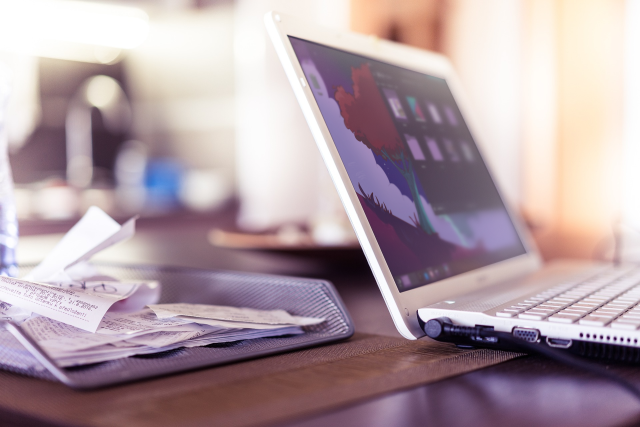 Photo of a laptop on a desk running Plasma 6
