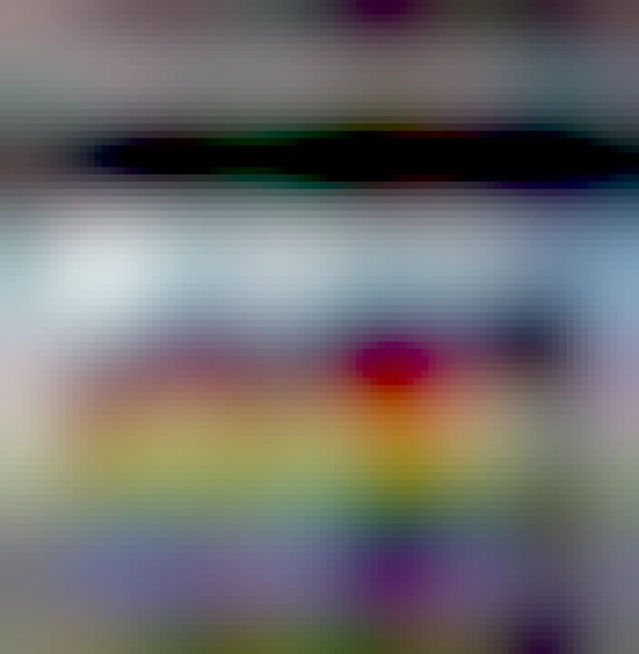 A screenshot of a tweet from Mike Sington. The text reads: "Omaha man paints his house in rainbow colors after neighbor said derogatory words to him about gay men "that didn't sit well"." This text is accompanied by the picture of a two story house that is painted red, orange, yellow, green, blue, and violet in line from top to bottom.