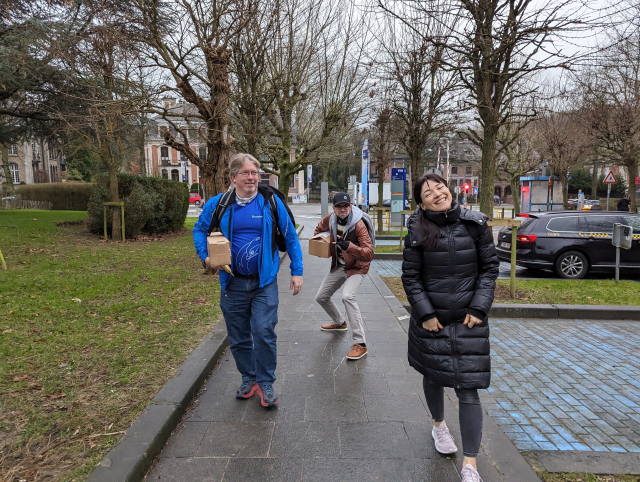 Members of Team Thunderbird on their way to Building K to set up the stand on a grey morning in Brussels, with one trying to be very stealthy on their approach!