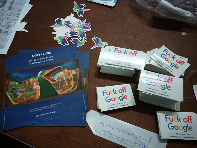 A pile of stickers which say 'Fuck off Google', stickers by La Contra-voie and flyers on digital organisation