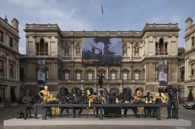 A life-sized reimagined installation of The Last Supper in front of a museum. 