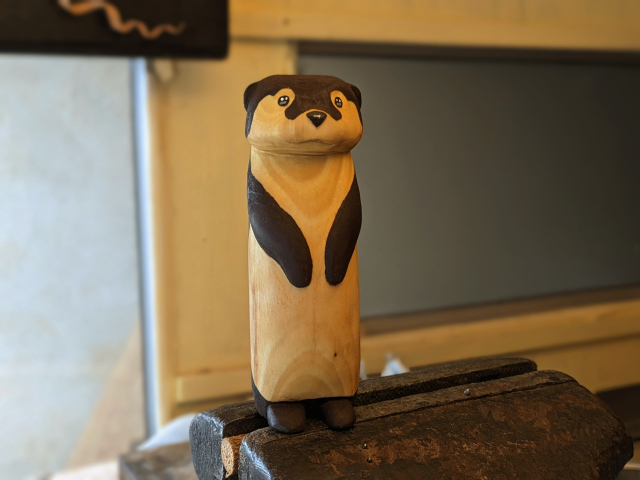 Wood sculpture of a standing otter