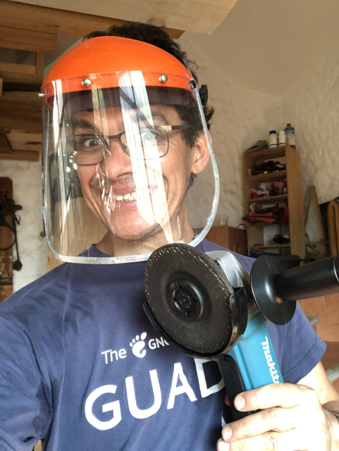 Federico sonriendo, con careta de protección, mientras muestra una esmeriladora angular.