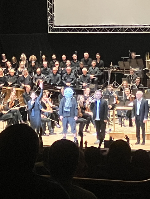 Yoko Taro, masked as usual, on stage