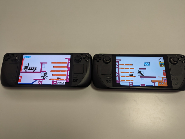 Two Steam Decks side by side showing the split-screen Game & Watch Mario Bros. game, with one screen on each Deck
