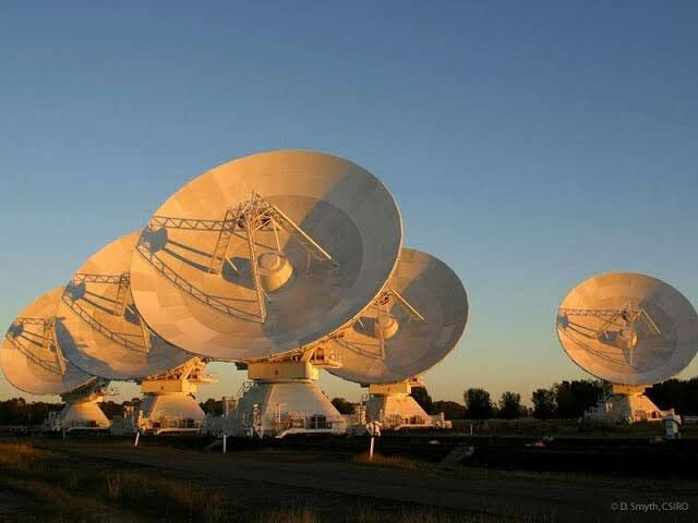 An array of five large radio telescopes. These are five of the six 22 metre dishes that make up the Australia Telescope Compact Array, otherwise known as ATCA (at-cuh).
