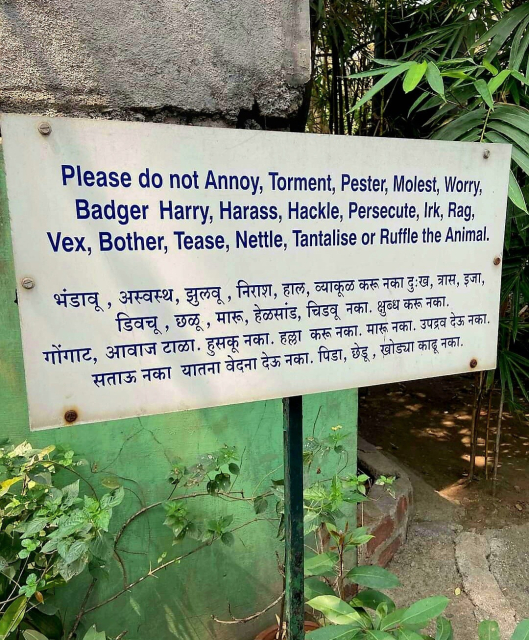 Sign in English and Hindi at a zoo in India. The sign reads: Please do not Annoy, Torment, Pester, Molest, Worry, Badger Harry, Harass, Hackle, Persecute, Irk, Rag, Vex, Bother, Tease, Nettle, Tantalise or Ruffle the Animal.