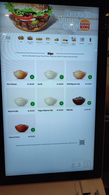 Overview of Burger King's touch screen ordering system. A bunch of sauces are listed, and at the bottom right the text "Activate Windows. Go to Settings to activate Windows." can be read.
