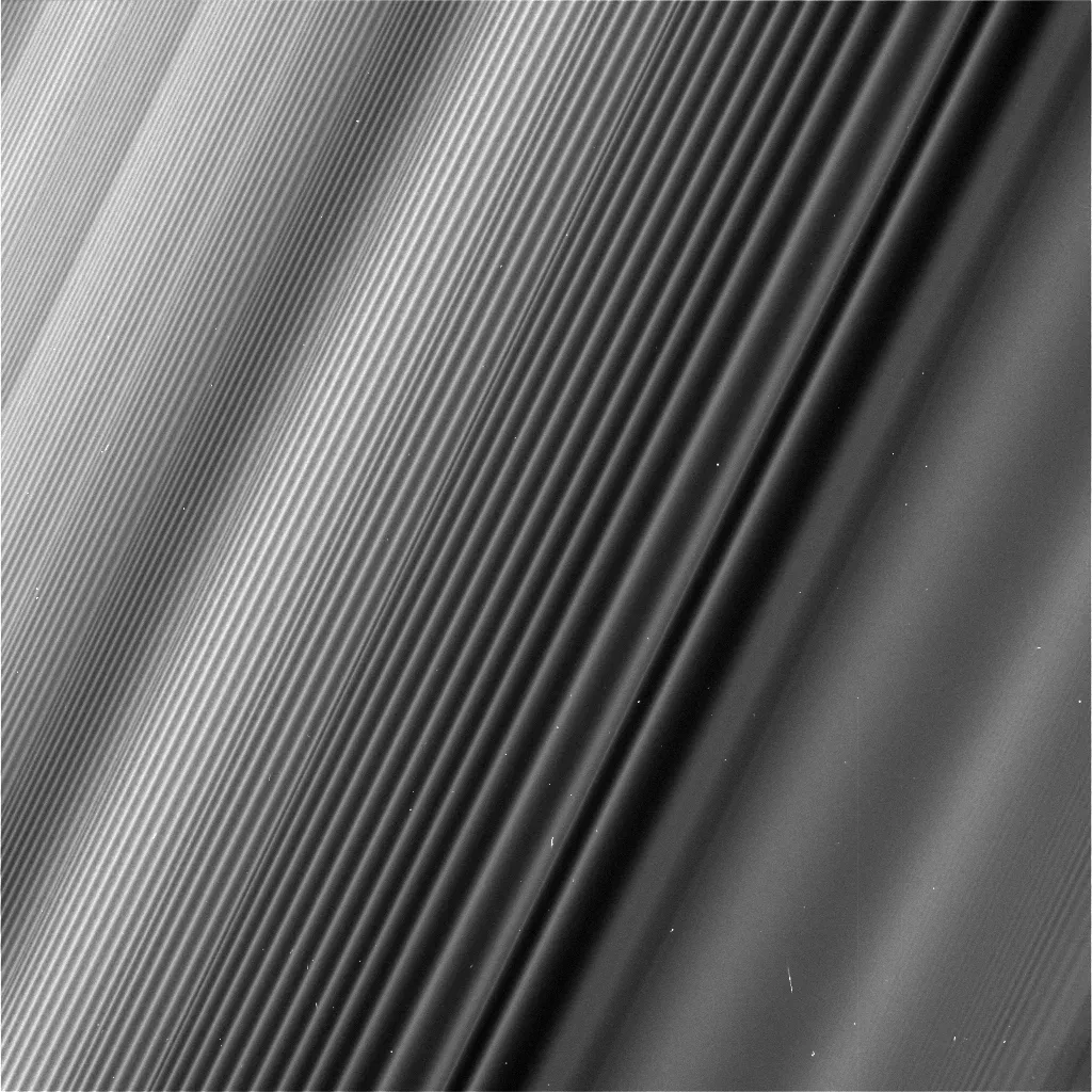 A tilted, near-side on view of saturn's rings. Density waves can be seen in the ring spirals, with different densities corresponding to historic gravitational changes in the Saturn system